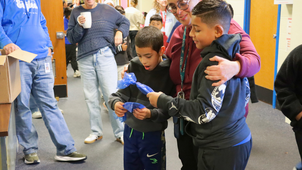 Two students reacting to winning prizes for perfect attendance for the start of school.