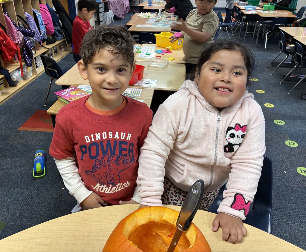 Students carving a pumpkin