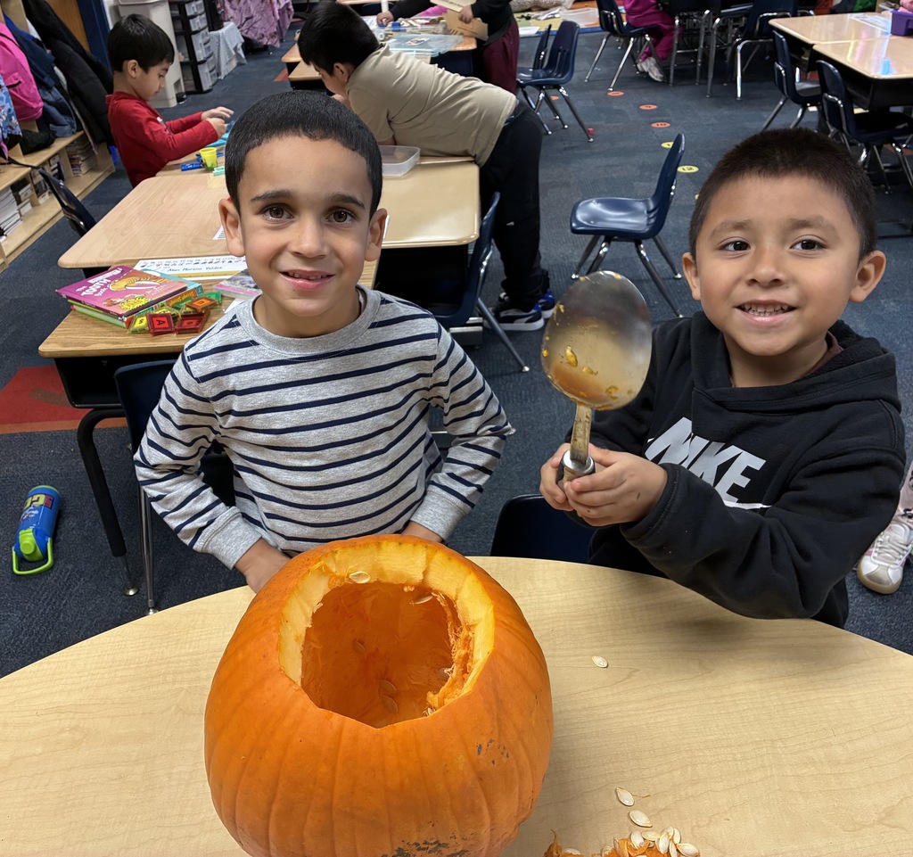 Students carving a pumpkin
