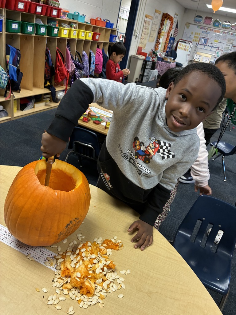 Students carving a pumpkin