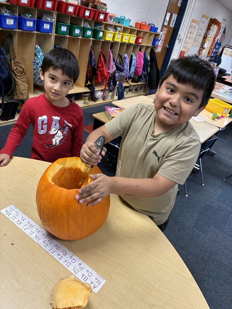 Students carving a pumpkin