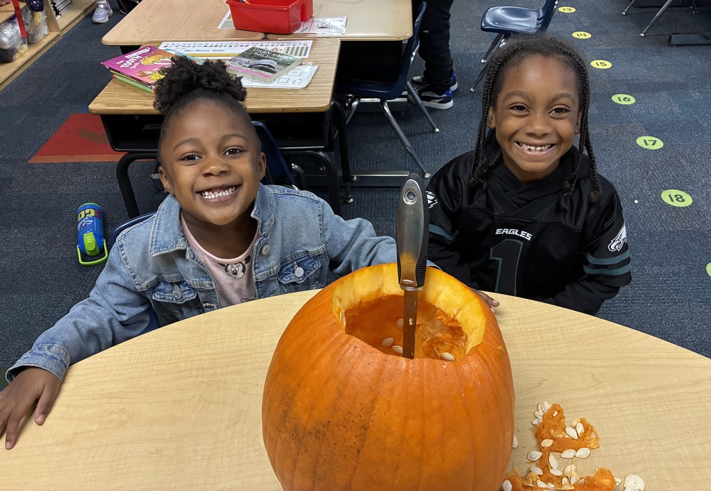 Students carving a pumpkin