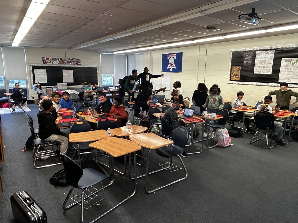 Students in classroom getting pizza party