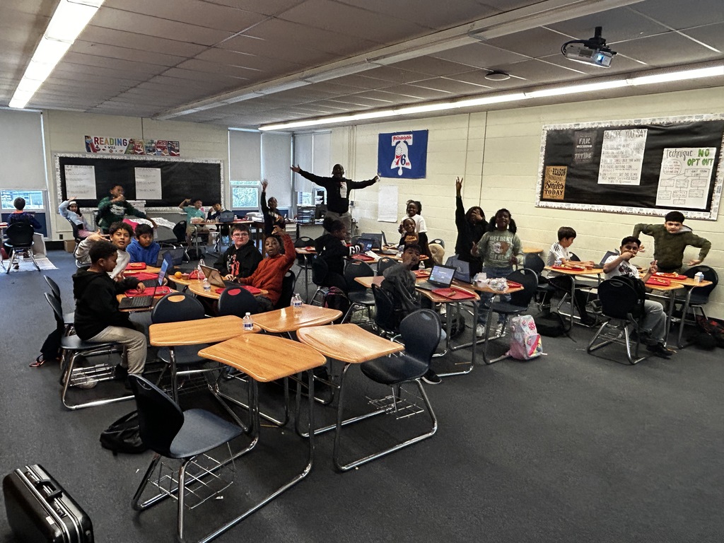 Students in classroom getting pizza party