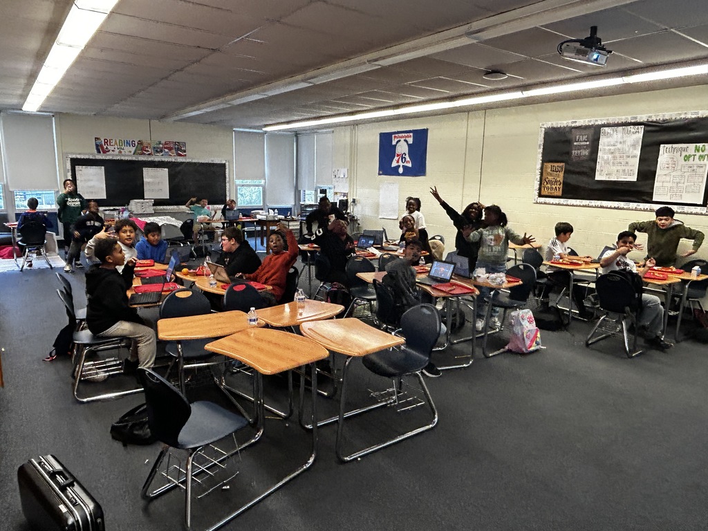 Students in classroom getting pizza party
