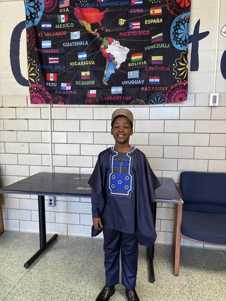 A student dresses in traditional clothing from his culture.