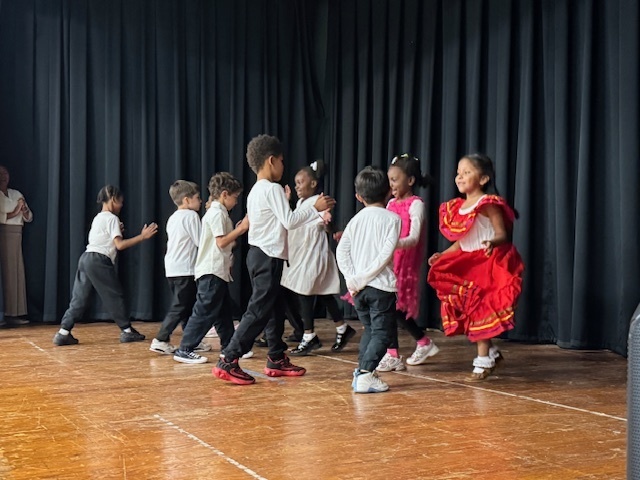 First grade students perform a traditional Mexican dance.