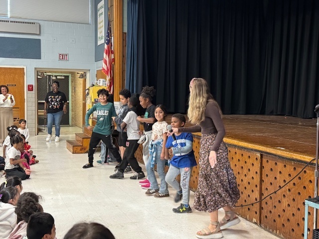 Ms. Turner moves along with third and fourth graders to a latin dance.