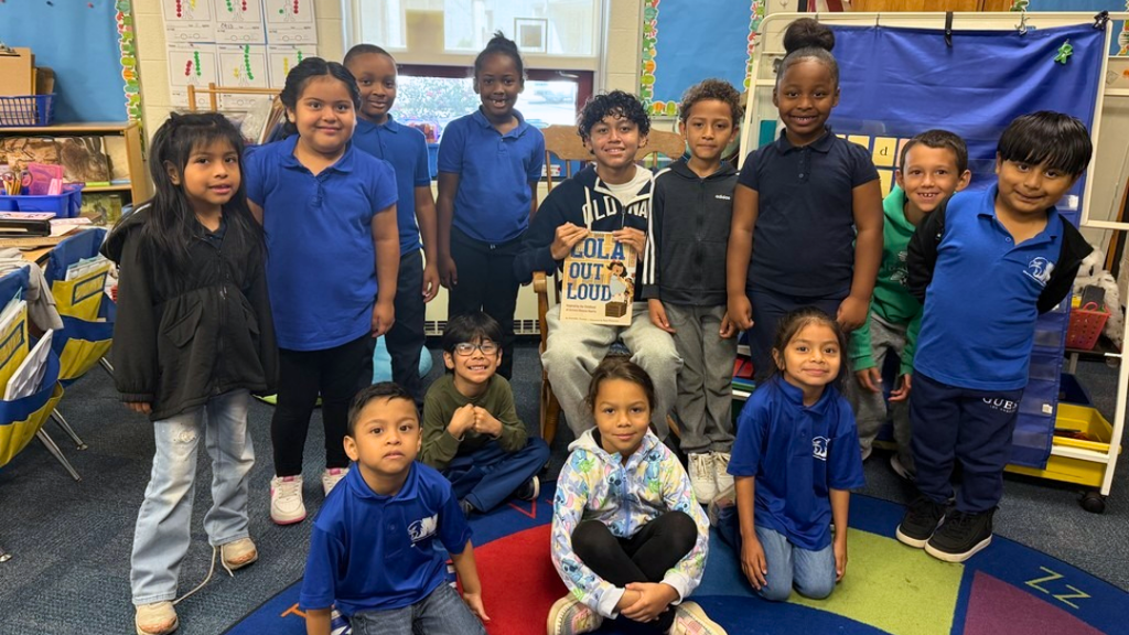 Class poses for a group photo with their guest reader from NAHS.