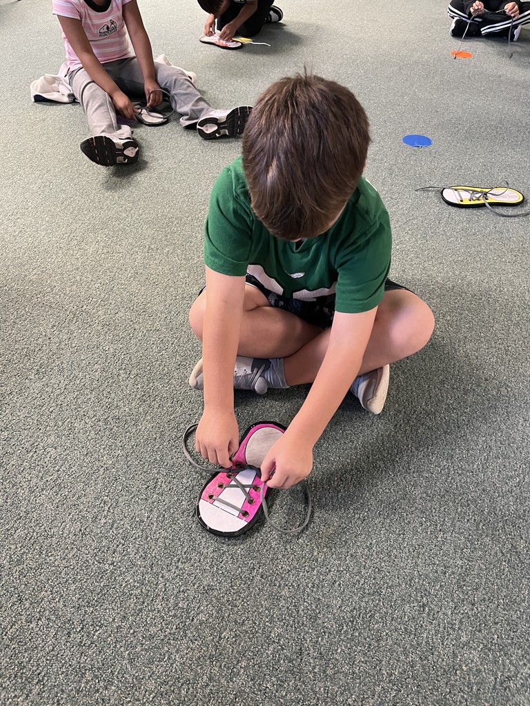 A 1st Grader with their practice shoe.