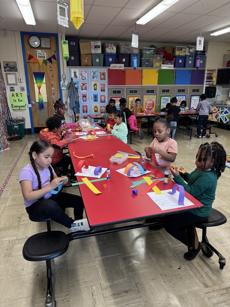 Kindergartners create rainbow paper line sculptures in art class.