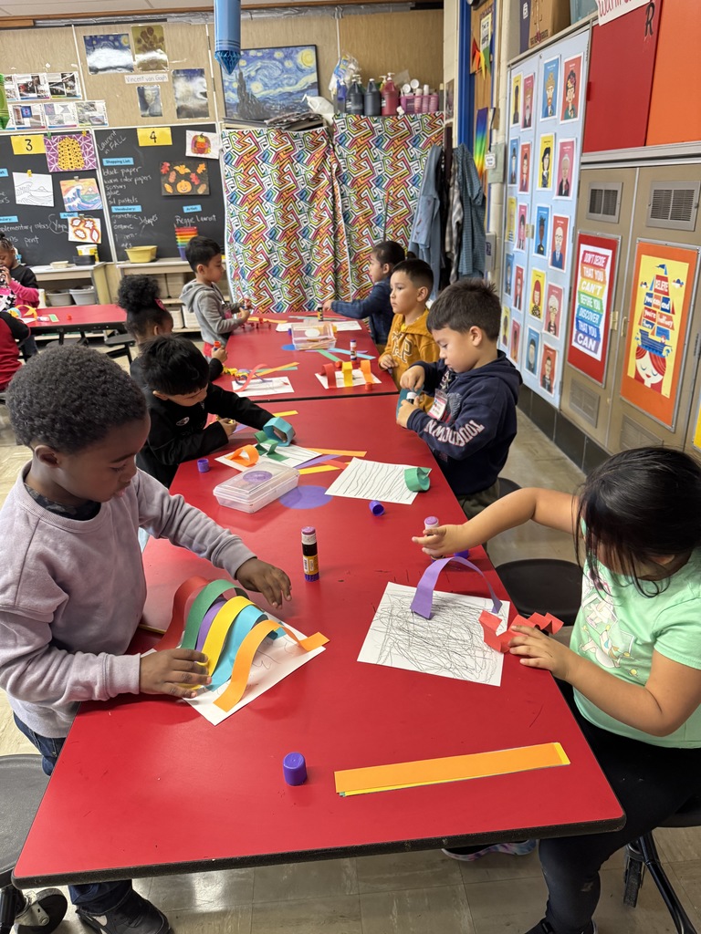 Kindergartners create rainbow paper line sculptures in art class.