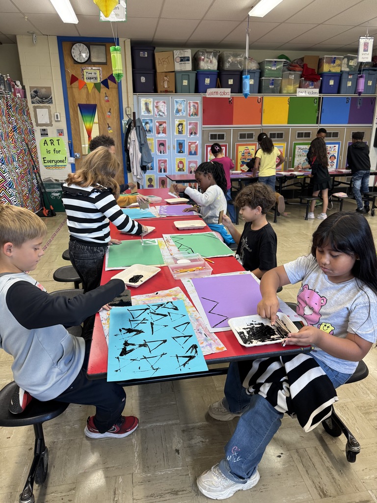Third graders create a printed background for their art projects.