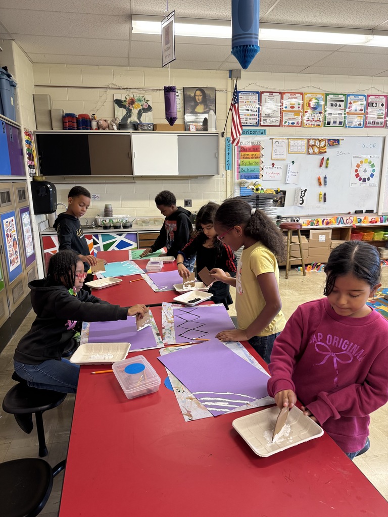 Third graders create a printed background for their art projects.