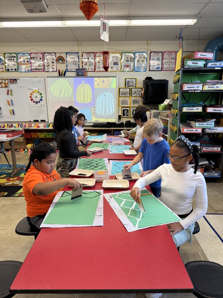 Third graders create a printed background for their art projects.