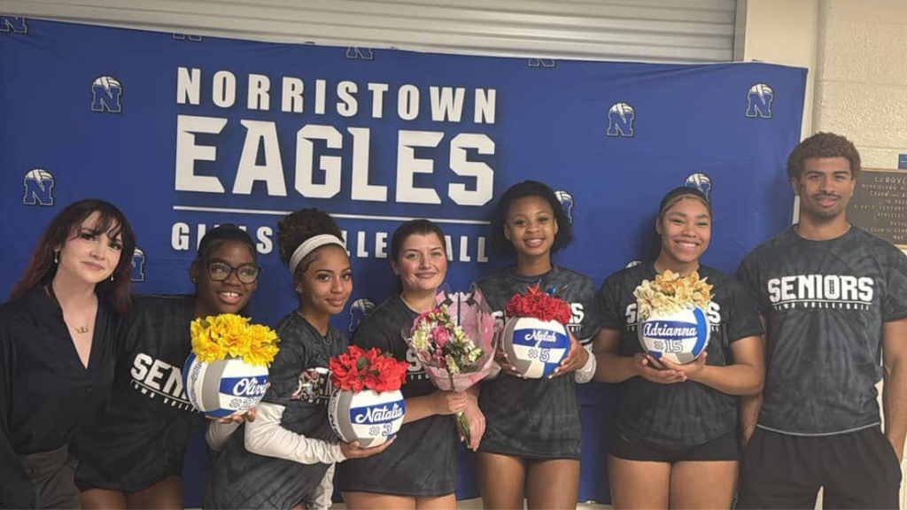 Girls Volleyball seniors pose for photo with coaches.