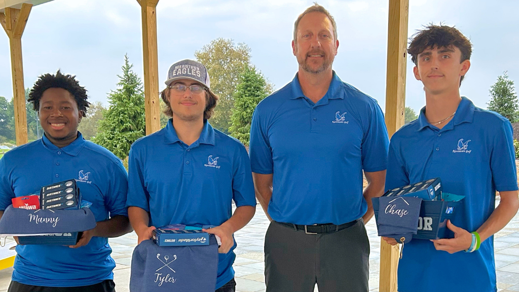 Three Golf Seniors pose for photo with their coach.