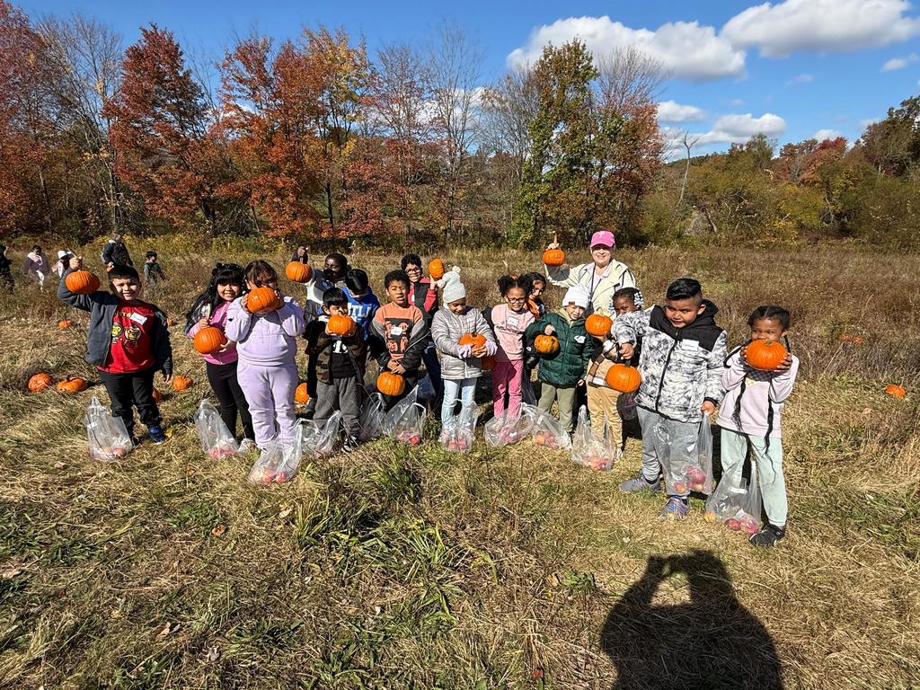 Mrs. Krause and her students stop for a photo after picking apples and pumpkins.
