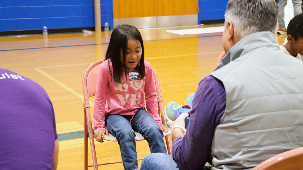 Student's reaction to seeing her new shoes.