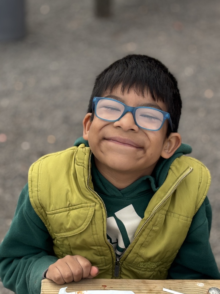 A student smiling at the farm