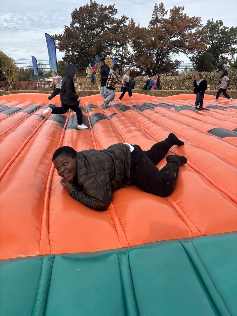 A student jumping on the blow up