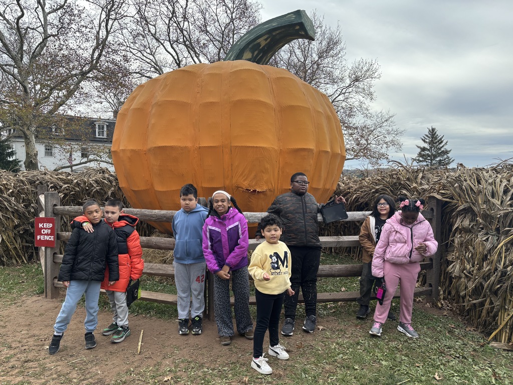 Students in front of the big pumpkin