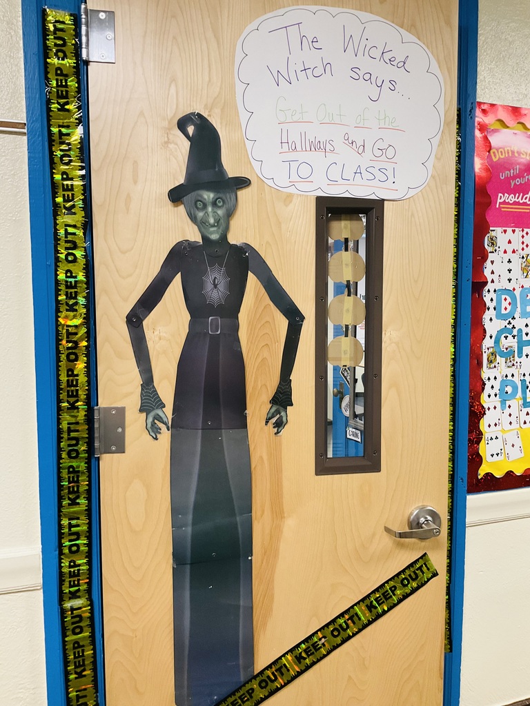 A door with a witch on it telling students to go to class.