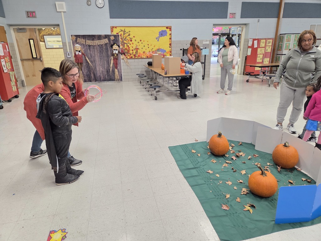 A Kindergartner plays a game at the Fall Fest.