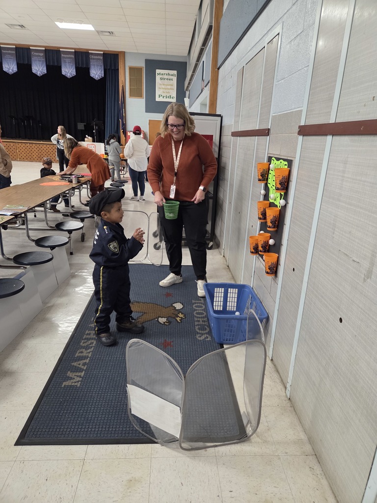 A Kindergartner plays a game at the Fall Fest.