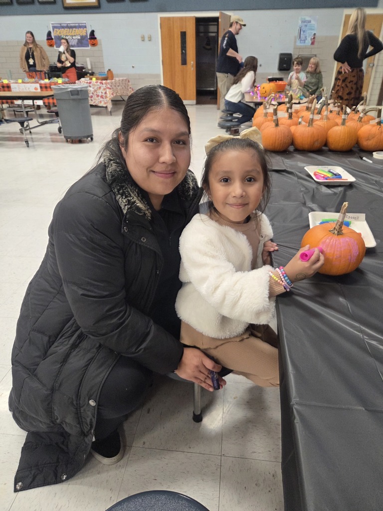 A student decorates a pumpkin at the Fall Fest.