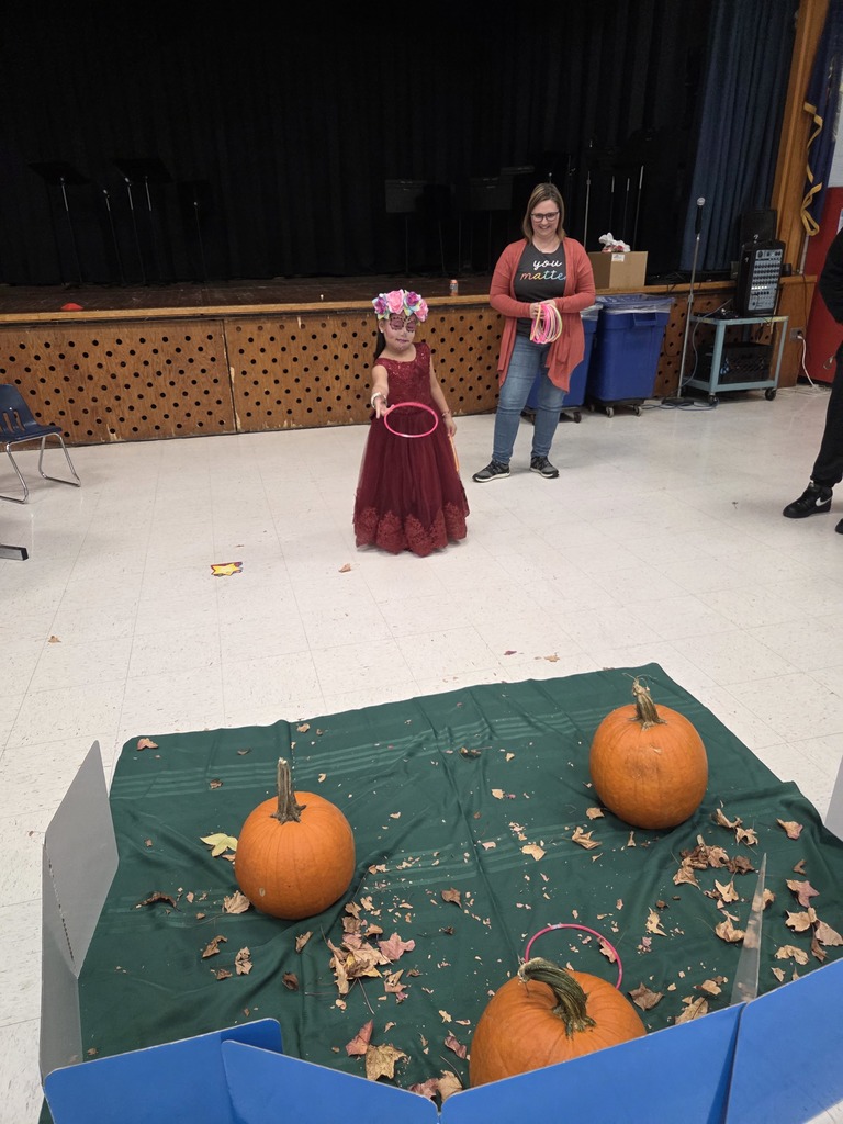 A Kindergartner plays a game at the Fall Fest.