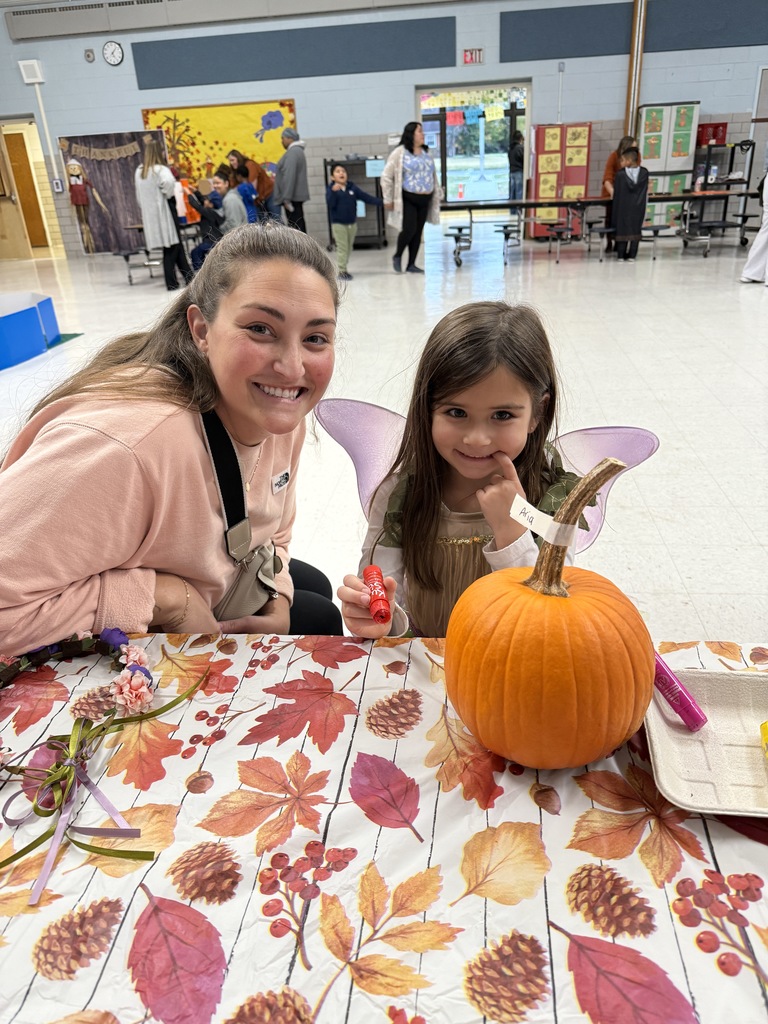 A student decorates a pumpkin at the Fall Fest.