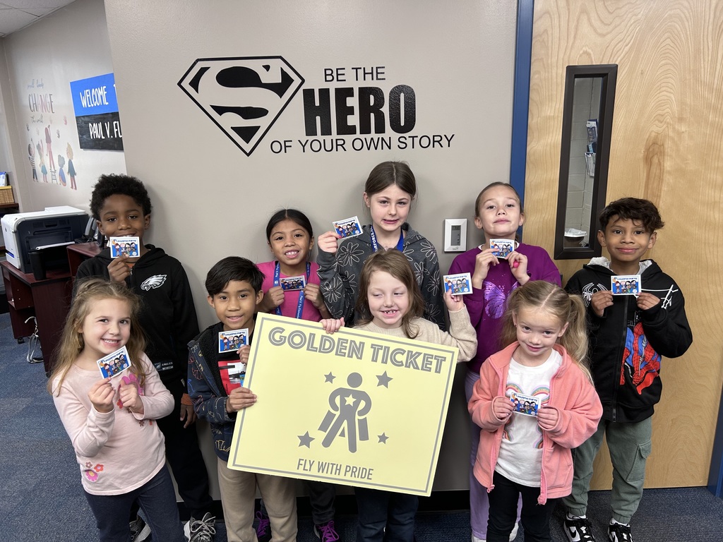 Golden ticket winners holding up their classroom pajama party passes.