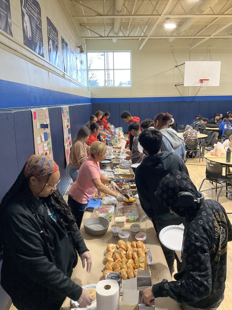 Students are being served Friendsgiving by staff in the cafeteria