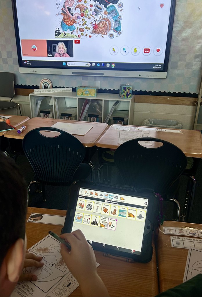 Students listening to the author read her book virtually to the students.