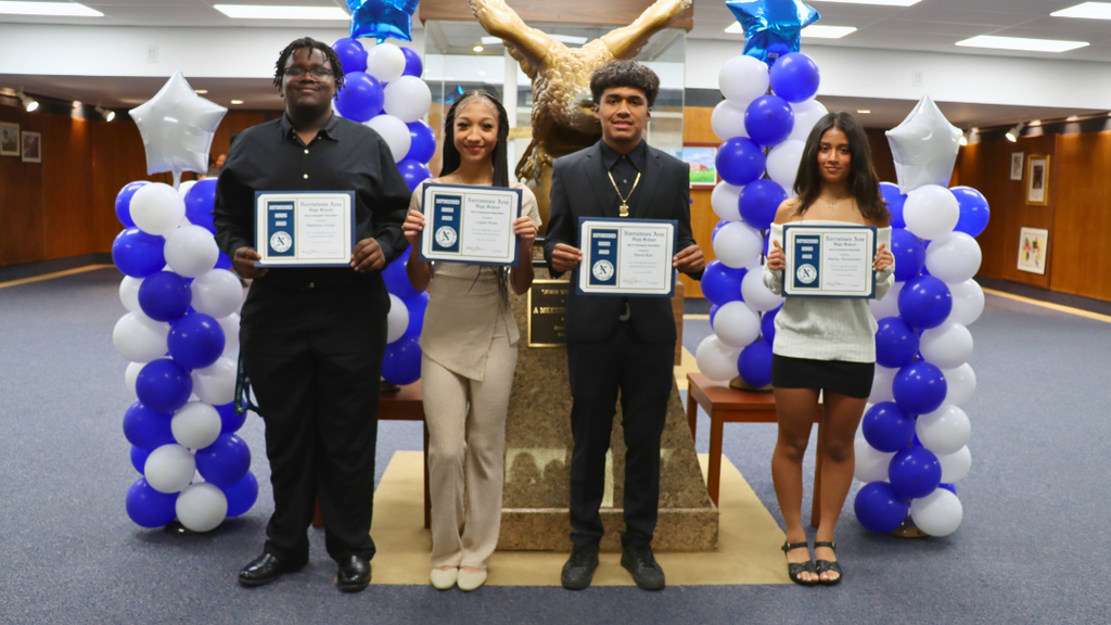 Outstanding student athletes pose for group photo in lobby.  