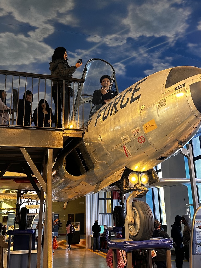 A student is sitting in an airplane display at the Franklin institute