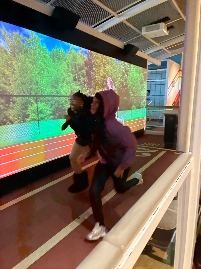 Two students are racing at a museum display.