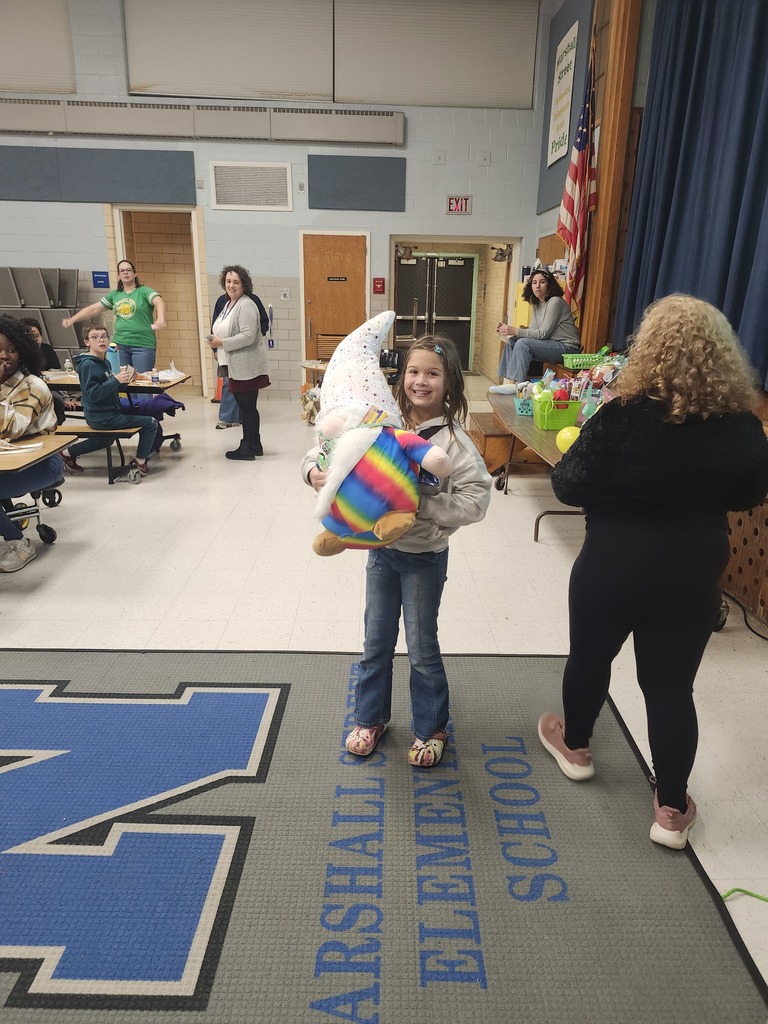 A student receives a prize at Bingo night.