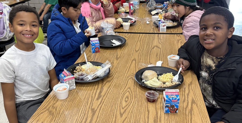 Students enjoy a Thanksgiving meal at lunch.