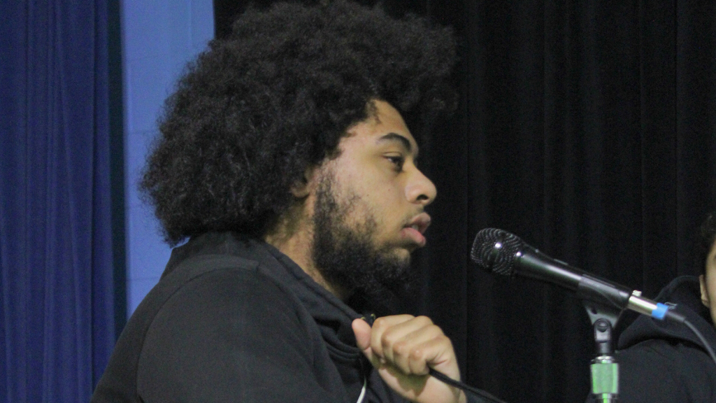 Student speaking into microphone.