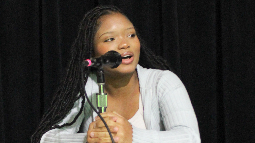 Student speaking into microphone.