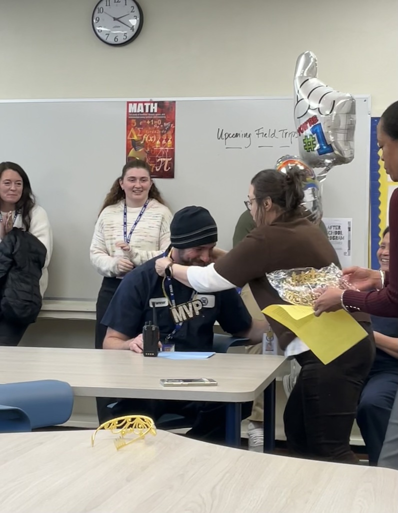 The custodian is being crowned as the team member of the month