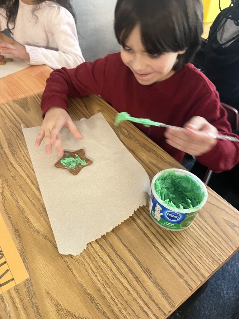 A student decorating his gingerbread cookie