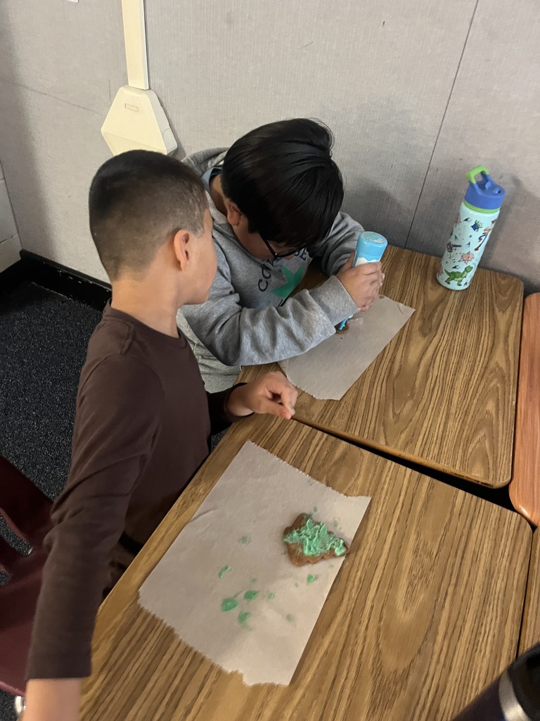 Students decorating their gingerbread cookies