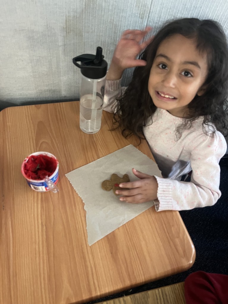 A student decorating her gingerbread cookie