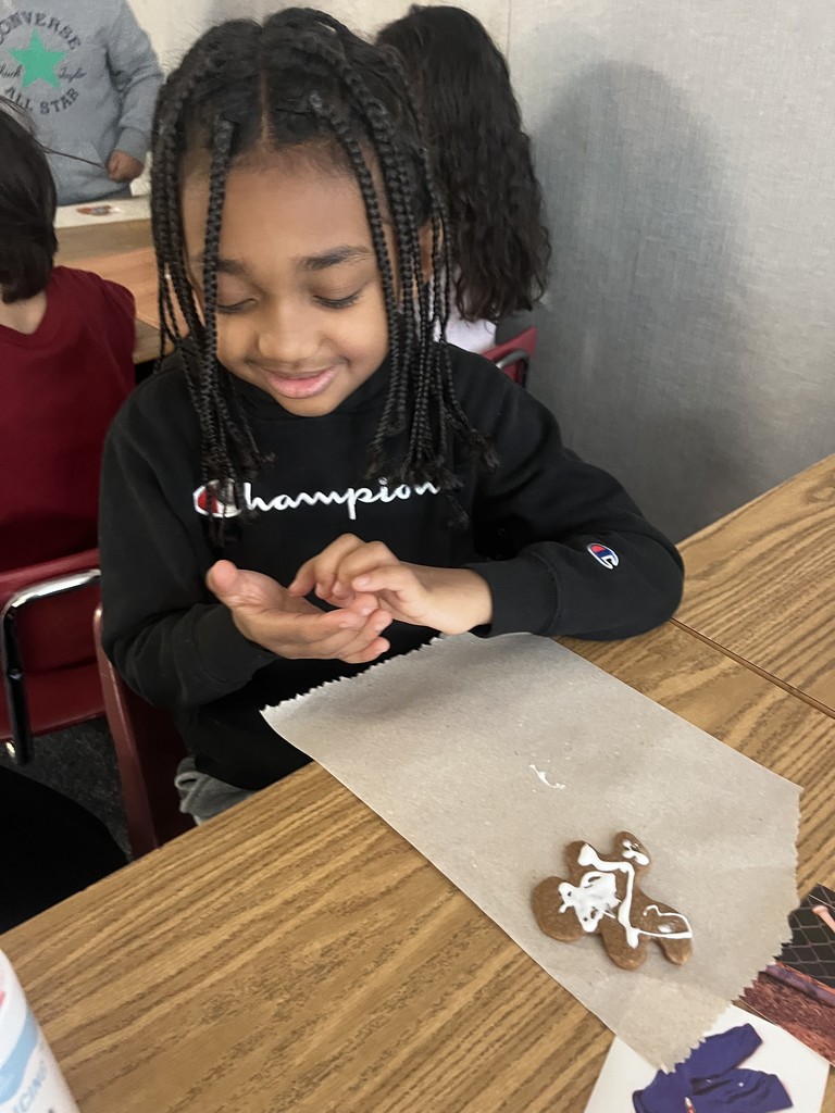 A student decorating his gingerbread cookie