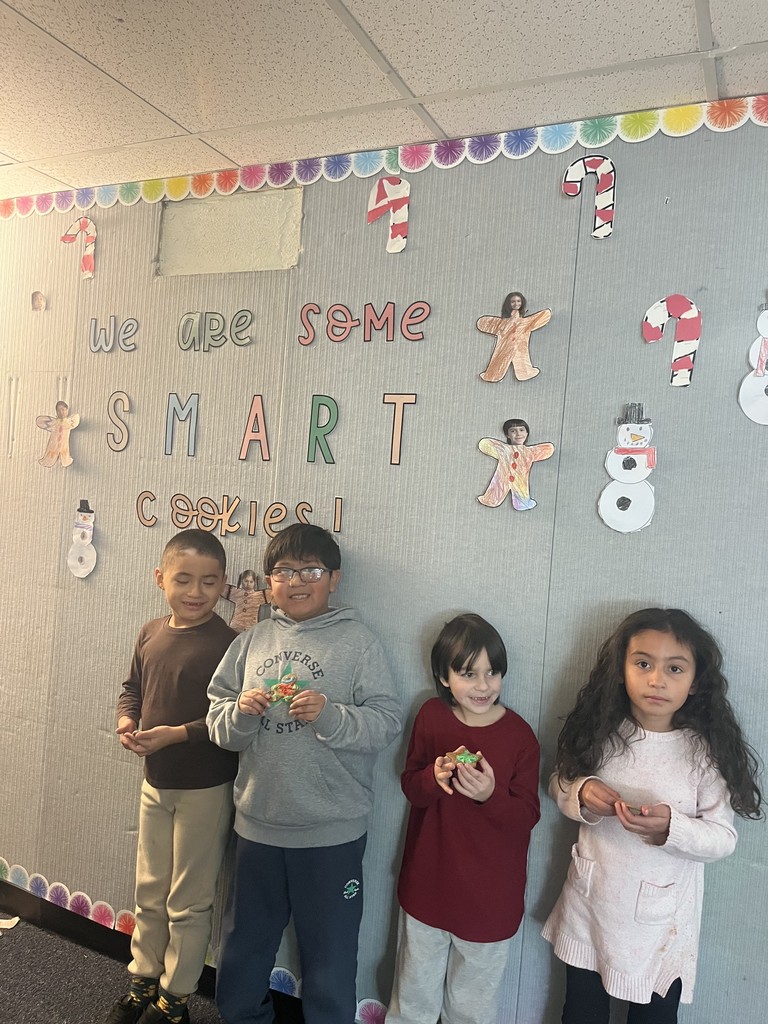 Students showing their decorated gingerbread cookies
