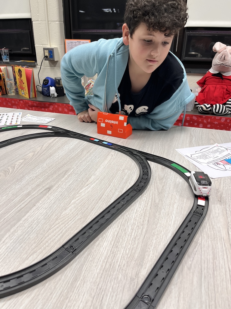 A student playing with a train at Polar Express Night