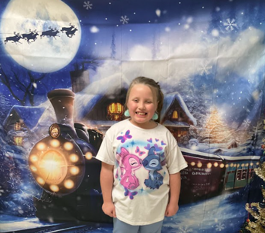 A student taking a photo at Polar Express Night